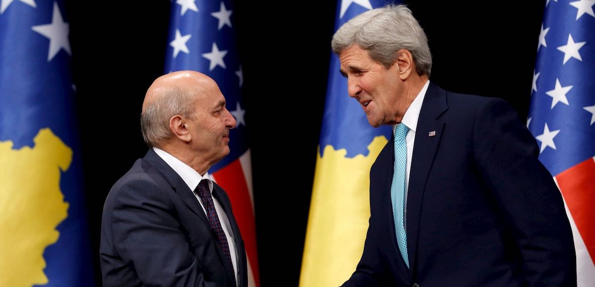 Kosovo's Prime Minister Isa Mustafa (L) and U.S. Secretary of State John Kerry shake hands after speaking to reporters following their meeting at Pristina International Airport Adem Jashari in Pristina, Kosovo December 2, 2015.
