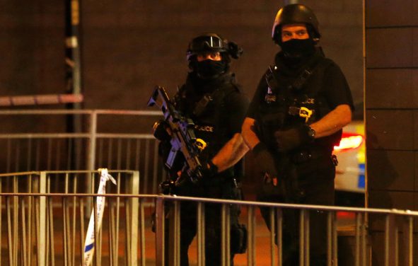 Armed police officers stand next to a police cordon outside the Manchester Arena, where U.S. singer Ariana Grande had been performing, in Manchester, northern England, Britain, May 23, 2017. (Photo: Reuters)