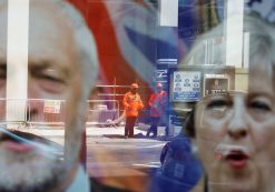 Workers in protective equipment are reflected in the window of a betting shop with a display inviting customers to place bets on tbe result of the general election with images of Britain's Prime Minister Theresa May and opposition Labour Party leader Jeremy Corbyn, in London, June 7, 2017. (Photo: Reuters)