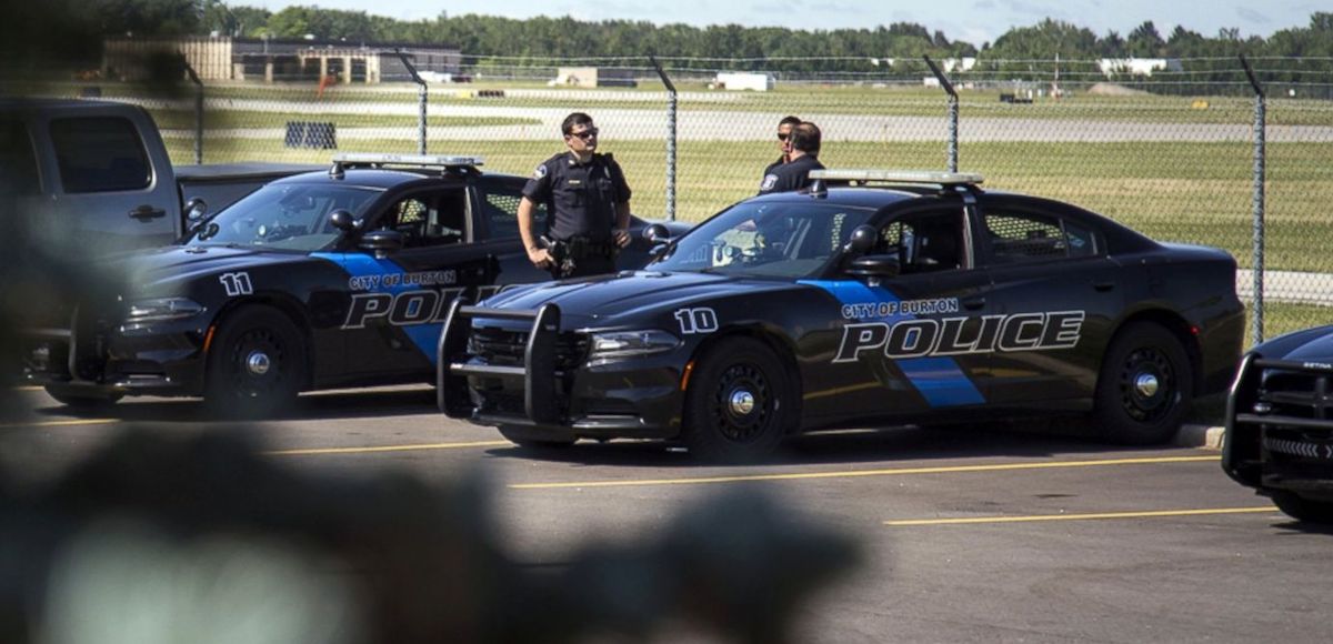 PHOTO: Burton Police Officers gather at Bishop International Airport, June 21, 2017. (Photo: AP)
