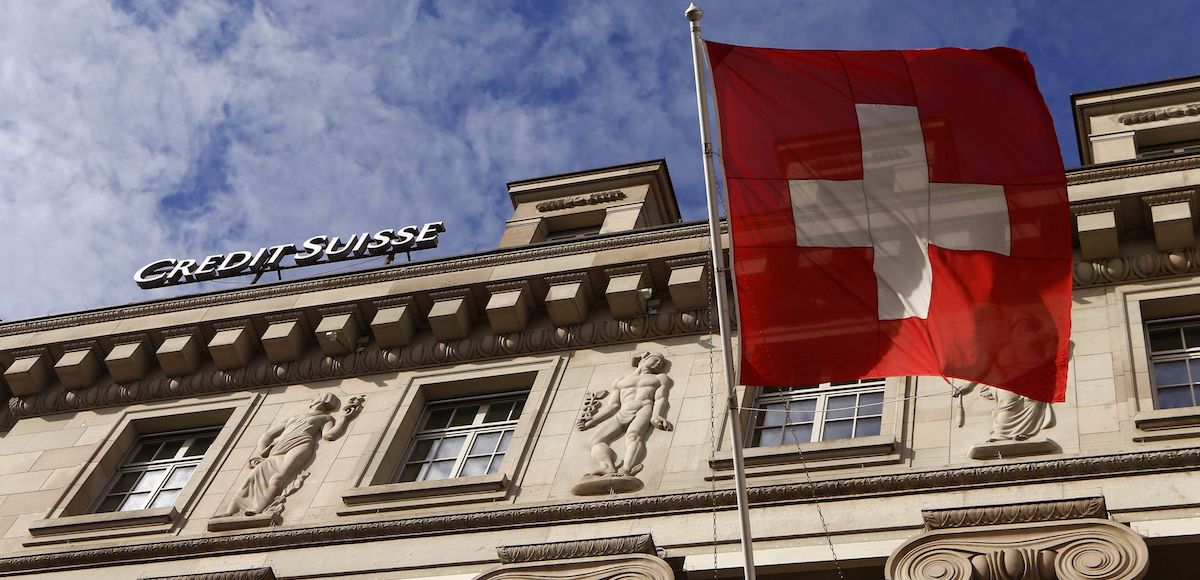 A national flag of Switzerland flies in front of a branch office of Swiss bank Credit Suisse in Luzern October 30, 2014. (Photo: Reuters)