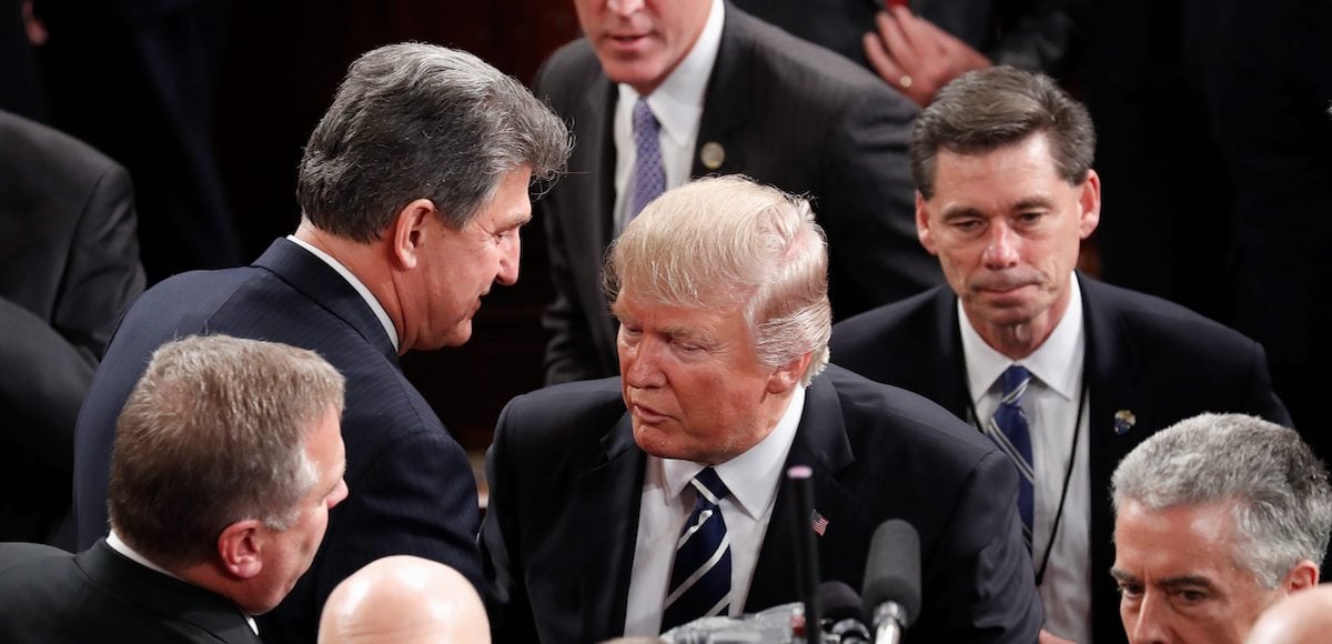 President Donald Trump walks past Sen. Joe Manchin, D-W.Va. on Capitol Hill in Washington, Tuesday, Feb. 28, 2017, following the president's address to a joint session of Congress. (Photo: AP)