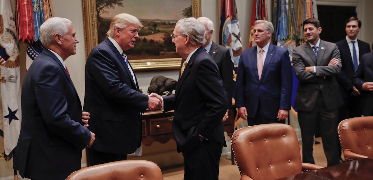 President Donald Trump, second from left, with Vice President Mike Pence, left, shakes hands with Senate Majority Leader Mitch McConnell, R-Kty., center, before the start of a meeting with House and Senate leaders at the White House. (Photo: AP)