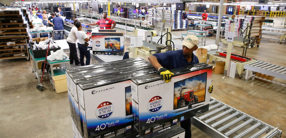 A worker stacks boxes of television sets after they have been assembled, checked and repackaged, before moving them to the warehouse at Element Electronics in Winnsboro, South Carolina May 29, 2014. (Photo: Reuters)