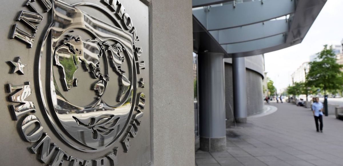 Pedestrians walk past the International Monetary Fund (IMF) headquarters’ complex in Washington Sunday, May 2, 2010. (Photo: AP)