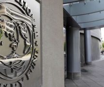 Pedestrians walk past the International Monetary Fund (IMF) headquarters’ complex in Washington Sunday, May 2, 2010. (Photo: AP)