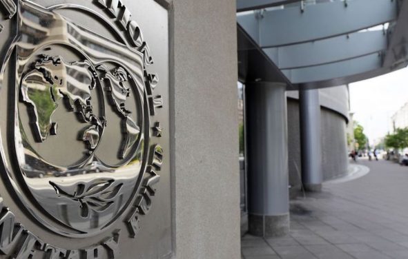 Pedestrians walk past the International Monetary Fund (IMF) headquarters’ complex in Washington Sunday, May 2, 2010. (Photo: AP)