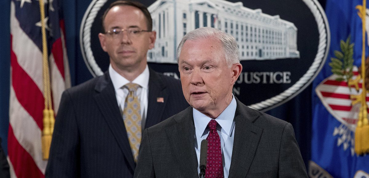 Attorney General Jeff Sessions, center, and Deputy Attorney General Rod Rosenstein, to his right, hold a press conference announcing the dismantling of the largest dark website in the world on July 20, 2017. (Photo: AP)