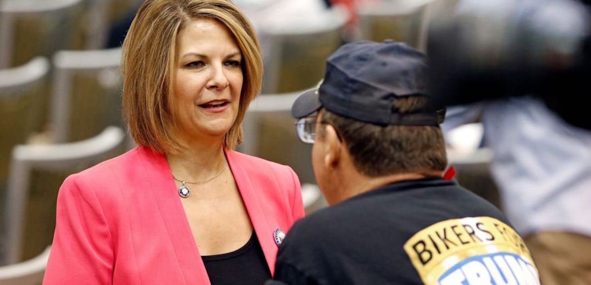 Kelli Ward, a rival of Sen. John McCain and candidate in the Arizona Republican primary for U.S. Senate in 2018, speaks with a supporter of President Donald J. Trump. (Photo: Associated Press)