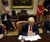 Director of the Office of Management and Budget Mick Mulvaney (L) and Treasury Secretary Steve Mnuchin (R) flank U.S. President Donald Trump as he hosts a 