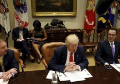 Director of the Office of Management and Budget Mick Mulvaney (L) and Treasury Secretary Steve Mnuchin (R) flank U.S. President Donald Trump as he hosts a 