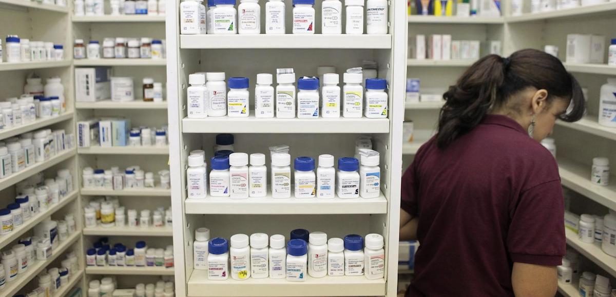 A pharmacy employee looks for medication as she works to fill a prescription while working at a pharmacy in New York December 23, 2009. (Photo: Reuters)