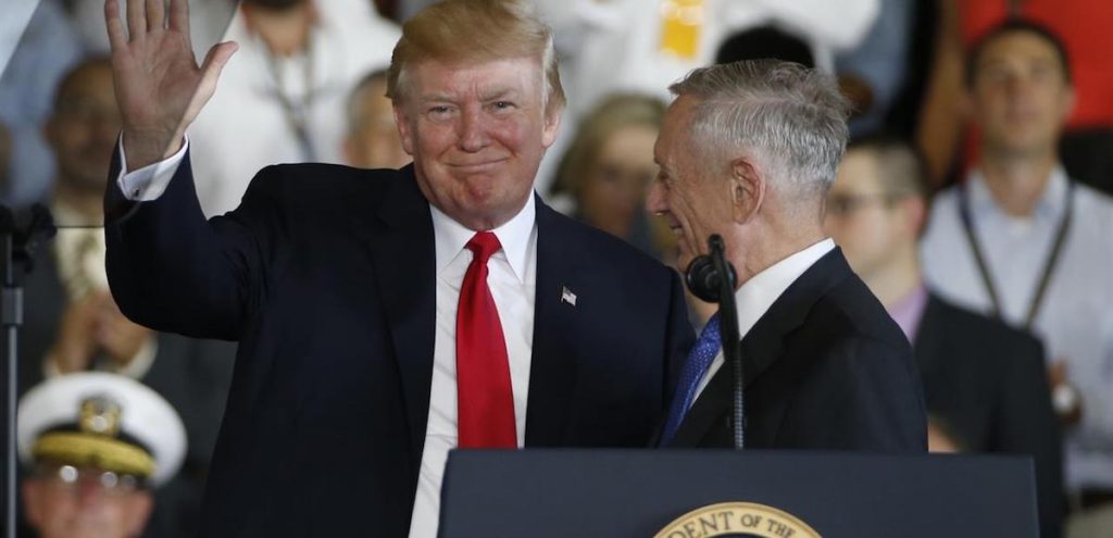 President Donald Trump left, waves to the crowd as he is introduced by Defense Secretary James Mattis, right, aboard the nuclear aircraft carrier USS Gerald R. Ford for it's commissioning at Naval Station Norfolk in Norfolk, Va., Saturday, July 22, 2017. (Photo: AP)