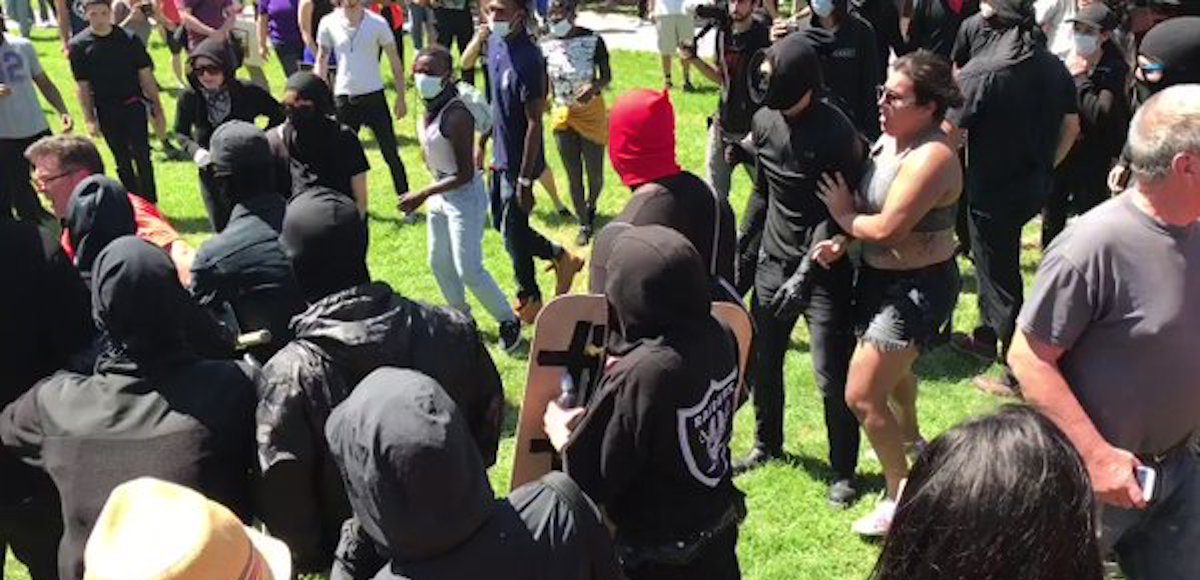 Antifa, otherwise known as so-called anti-fascists, attack journalists outside Martin Luther King Jr. Civic Center Park in Berkeley, California, on Sunday, August 27th, 2017.