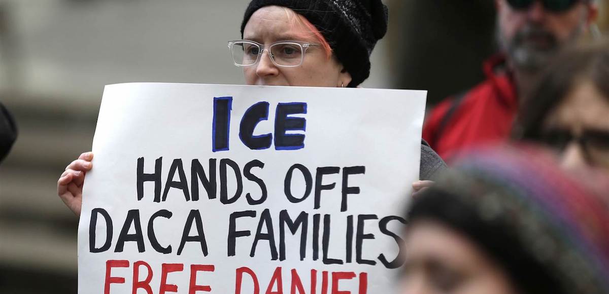 In this Feb. 17, 2017, photo, a protester holds a sign that reads "ICE Hands Off DACA Families Free Daniel," during a demonstration in front of the federal courthouse in Seattle. (Photo: AP)