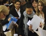 Job seekers adjust their paperwork as they wait in line to attend a job fair in New York February 28, 2013. (Photo: Reuters)