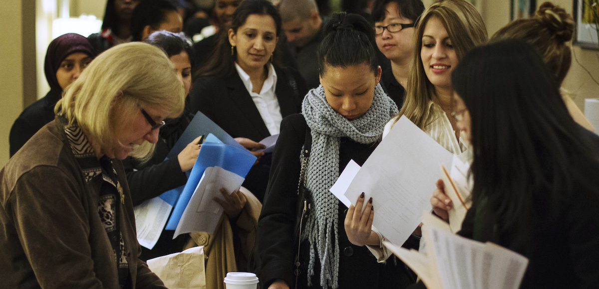 Job seekers adjust their paperwork as they wait in line to attend a job fair in New York February 28, 2013. (Photo: Reuters)