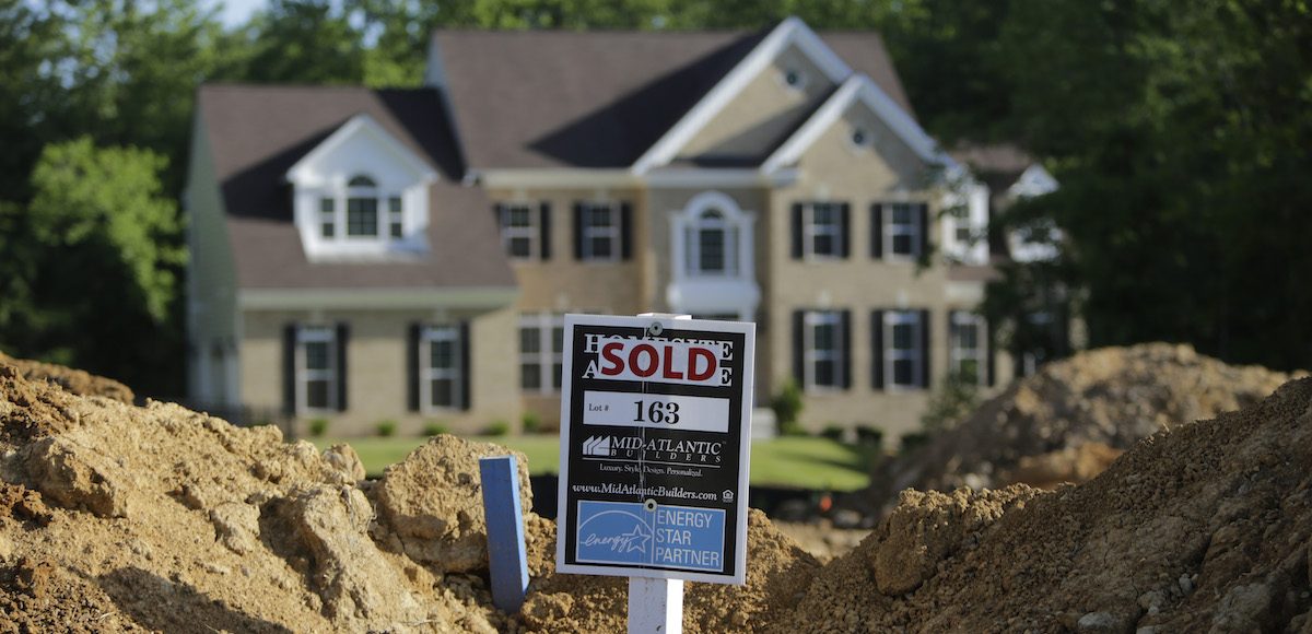 A completed house (rear) is seen behind the earthworks of a home currently under construction at the Mid-Atlantic Builder's 'The Villages of Savannah' development site in Brandywine, Maryland May 31, 2013. (Photo: Reuters)