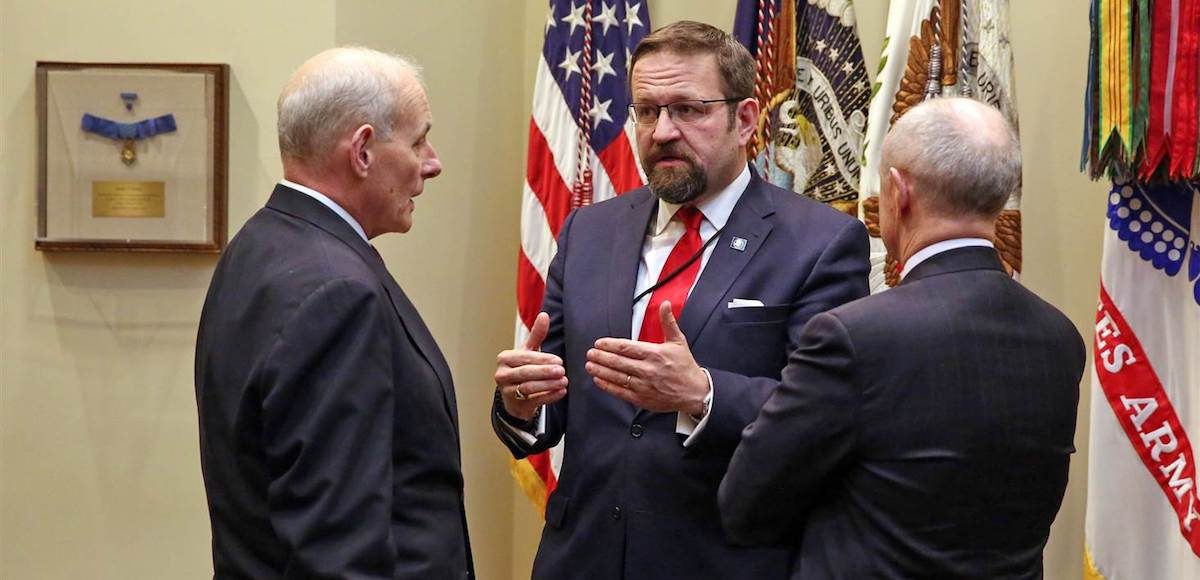 Dr. Sebastian Gorka, center, talks with Homeland Security Secretary John F. Kelly, left, before a meeting with President Donald Trump on cyber security at the White House in January. (Photo: AP)