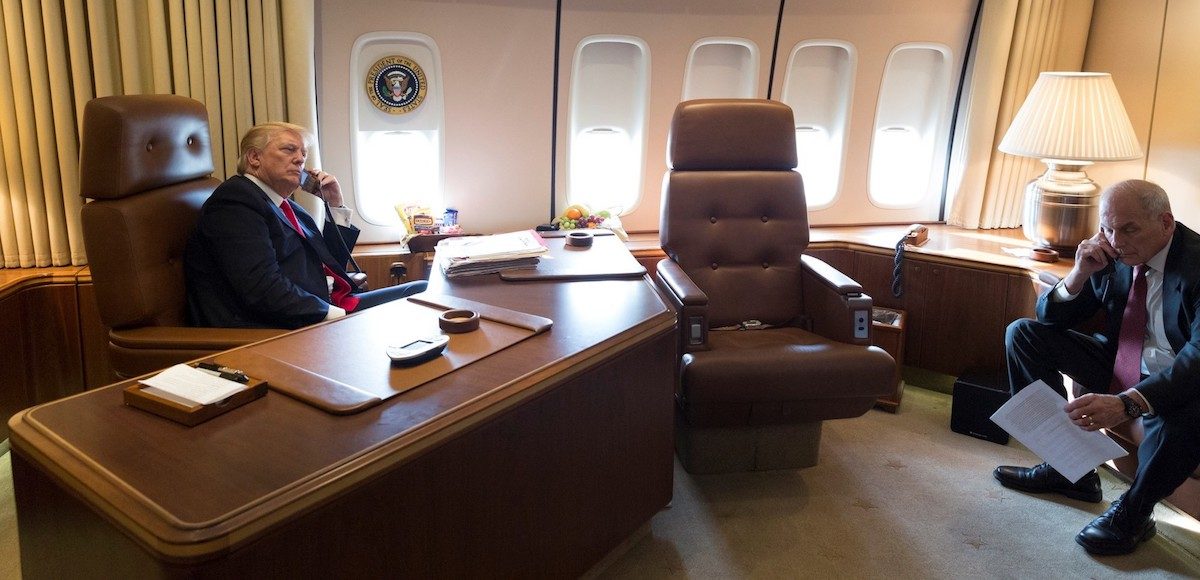 President Donald J. Trump speaks with Texas Governor Greg Abbott while aboard Air Force One, as Chief of Staff General John Kelly listens, en route to Joint Base Andrews in Washington, D.C., Wednesday August 30, 2017. (Official White House Photo by Joyce N. Boghosian)