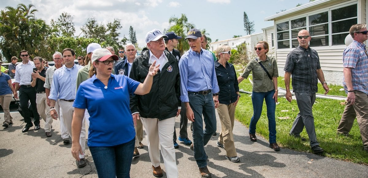 Florida Gov. Rick Scott escorts President Donald Trump and Vice President Mike Pence surveying from the damage from Hurricane Irma in Fort Myers, Florida on Thursday, September 14, 2017.
