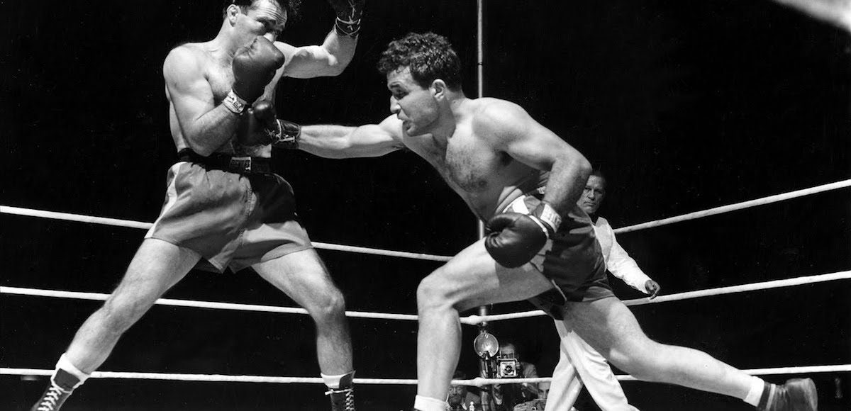 Jake LaMotta, right, finds Algerian Marcel Cerdan wide open and sends a right in third round action of their world middleweight championship title bout in Briggs Stadium, Detroit, Mich., June 16, 1949. LaMotta knocked out Cerdan in the tenth round to become the new world middleweight champion. (AP Photo)
