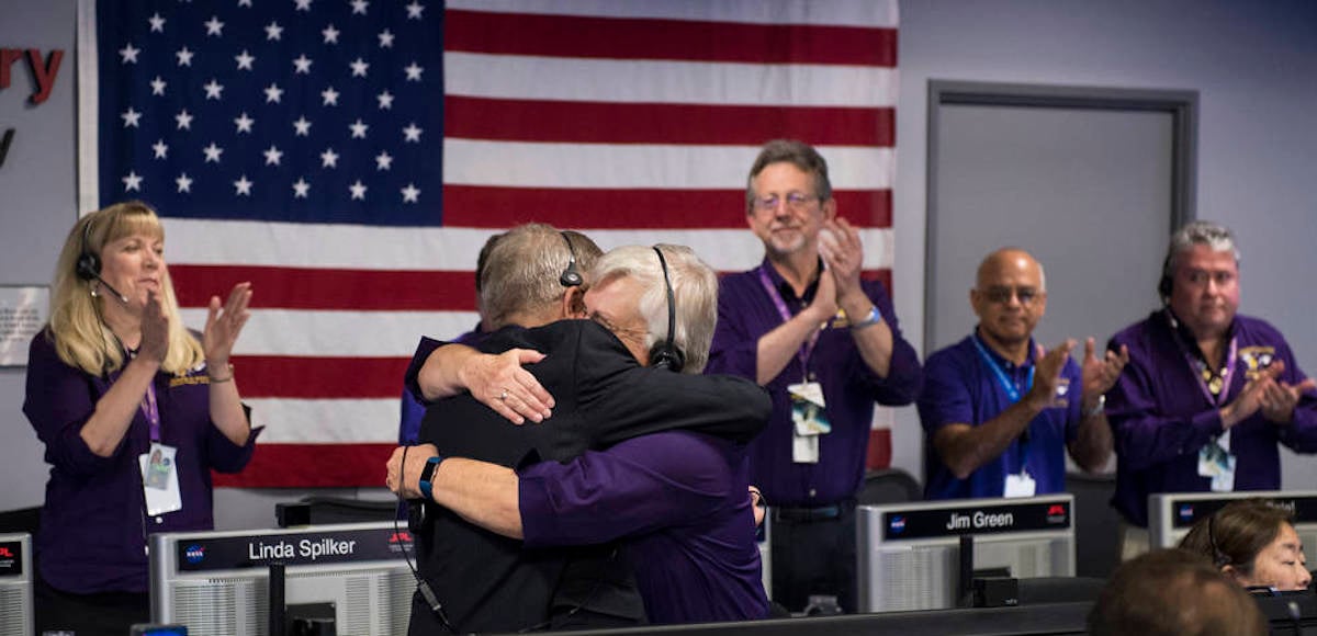 Cassini program manager at JPL, Earl Maize, left, and spacecraft operations team manager for the Cassini mission at Saturn, Julie Webster, right, embrace after the Cassini spacecraft plunged into Saturn, Friday, Sept. 15, 2017 at NASA's Jet Propulsion Laboratory in Pasadena, California. Since its arrival in 2004, the Cassini-Huygens mission has been a discovery machine, revolutionizing our knowledge of the Saturn system and captivating us with data and images never before obtained with such detail and clarity. On Sept. 15, 2017, operators will deliberately plunge the spacecraft into Saturn, as Cassini gathered science until the end. The “plunge” ensures Saturn’s moons will remain pristine for future exploration. During Cassini’s final days, mission team members from all around the world gathered at NASA’s Jet Propulsion Laboratory, Pasadena, California, to celebrate the achievements of this historic mission. Photo Credit: (NASA/Joel Kowsky)