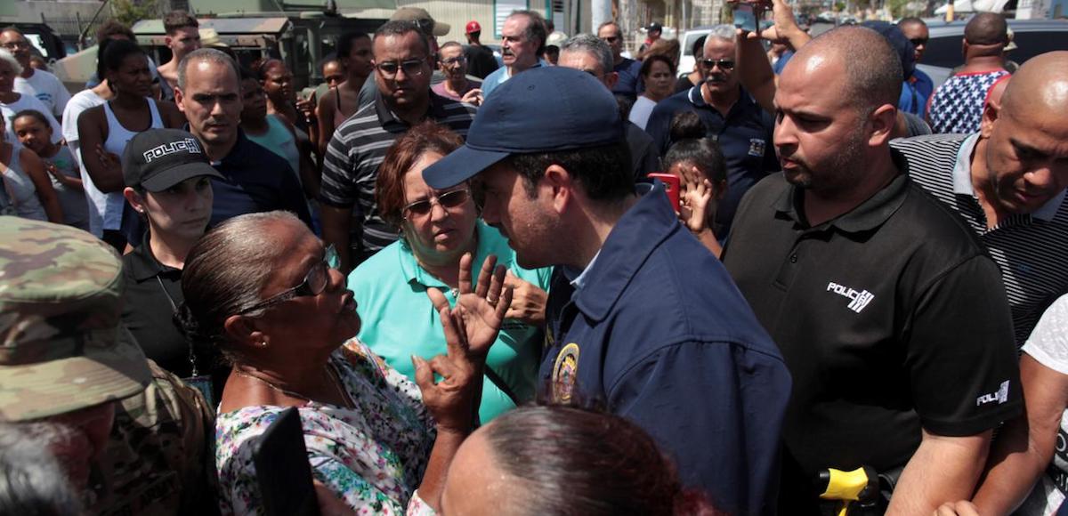 Puerto Rico Governor Ricardo Rossello, center, talks to a woman during a distribution of relief items, after the area was hit by Hurricane Maria in San Juan, Puerto Rico September 24, 2017. (Photo: Reuters)