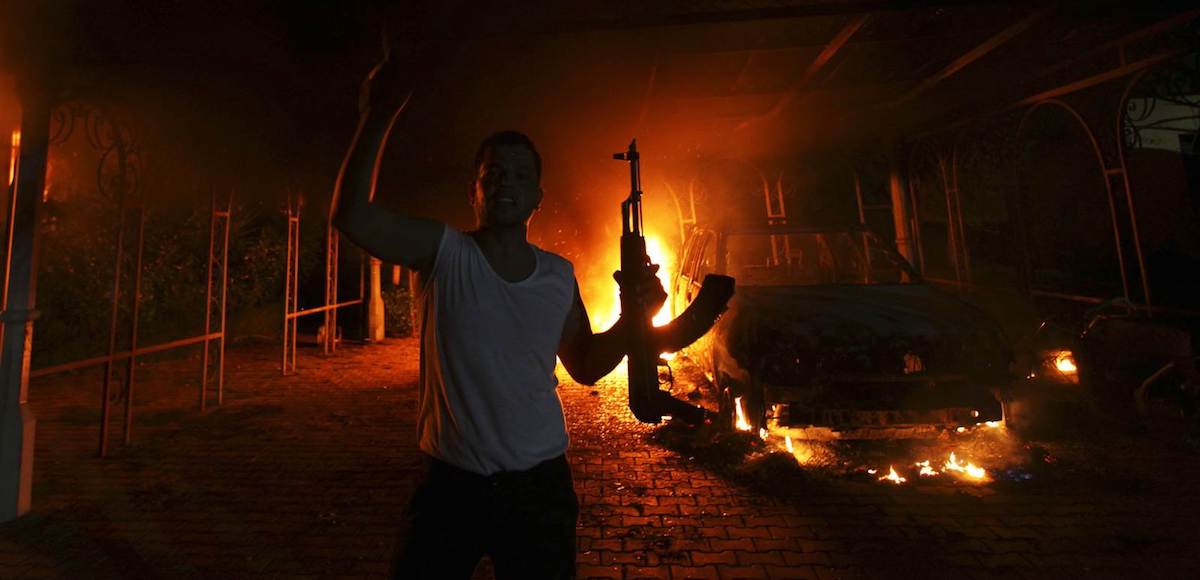 An Islamic extremist celebrates as the U.S. Consulate in Benghazi burns after the terror attack that claimed the lives of 4 Americans on September 11, 2012. (Photo: Reuters)