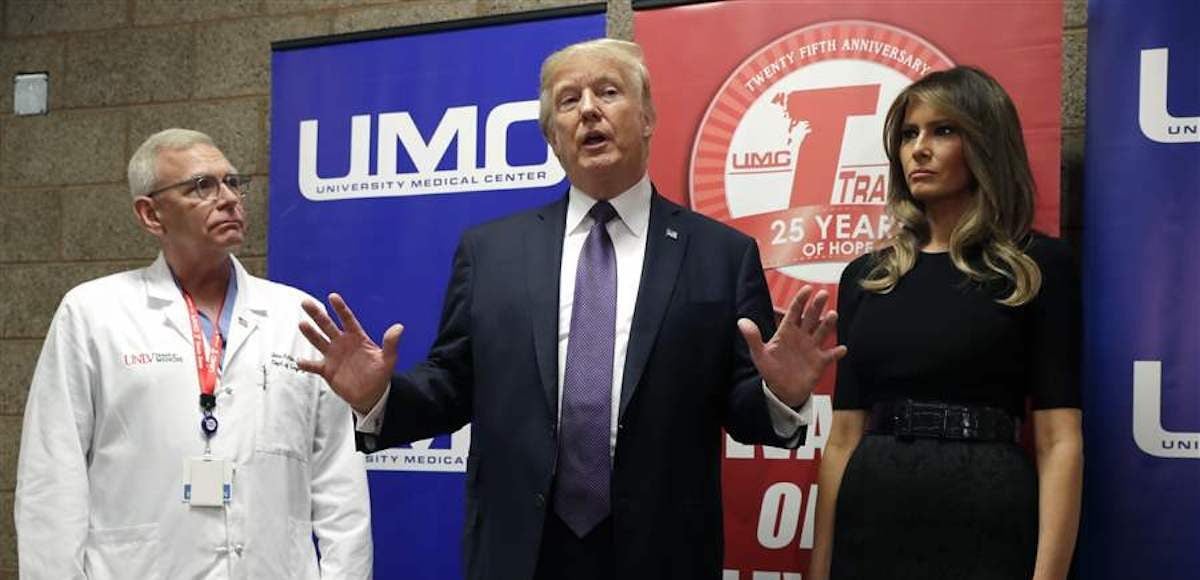 President Donald Trump talks as First Lady Melania Trump and surgeon Dr. John Fildes listens at the University Medical Center after Trump met with survivors of the mass shooting on Wednesday, October 4, 2017, in Las Vegas. (Photo: AP)