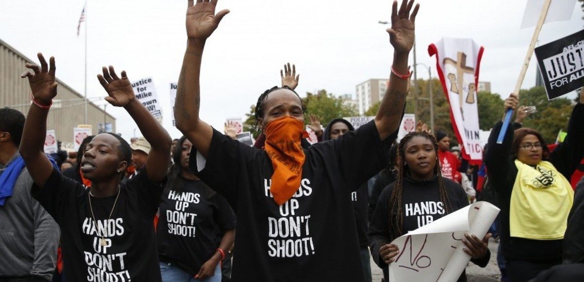 Members of various black rights and black supremacist groups protest the death of 18-year-old Michael Brown, who a friend falsely claimed had his hands in the air when Officer Darren Wilson fired. The "Hands Up, Don't Shoot" mantra was repeated even after it was disproven by forensic evidence and witness testimony. (Photo: Reuters)