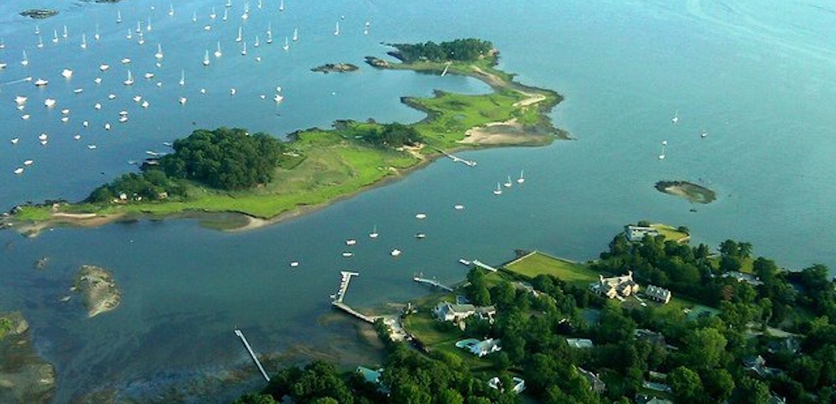 Hen Island, the location of primitive-living cottages less than 500 feet from the shores of Rye, New York, scene from above in the Long Island Sound.