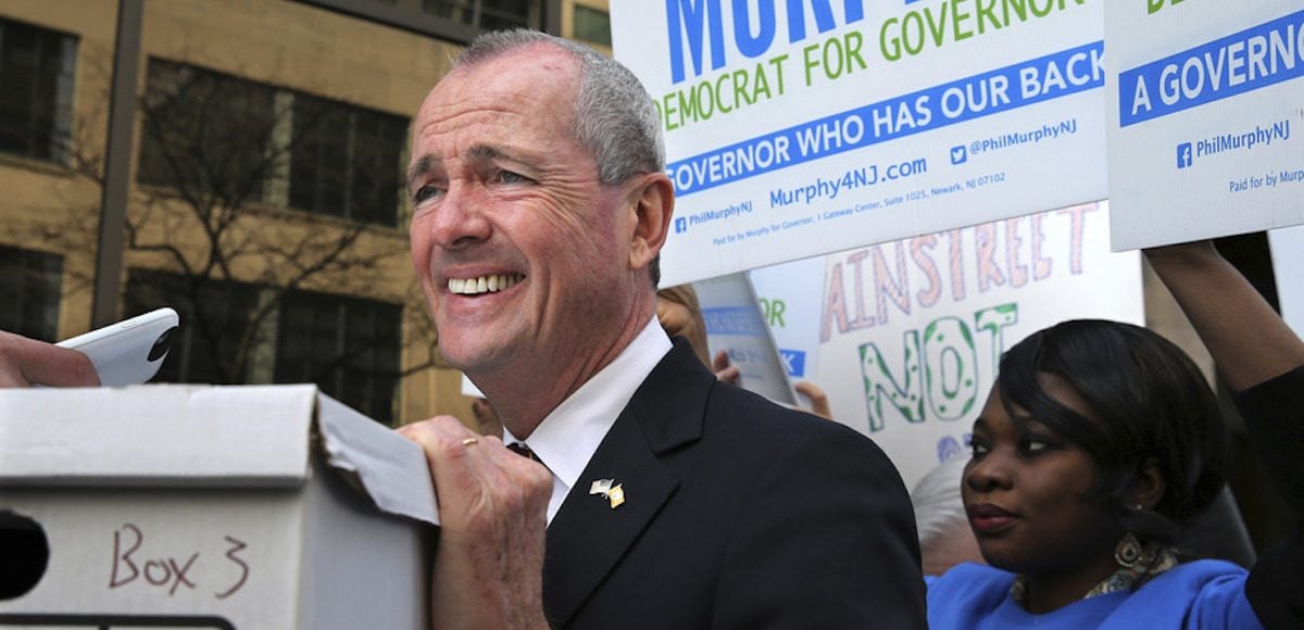 New Jersey Democratic gubernatorial candidate Phil Murphy rests his hand on a box of petitions as he answers a question before delivering the petitions to meet Monday's deadline for candidates to file petitions to run, Monday, April 3, 2017, in Trenton, N.J. (Photo: AP)