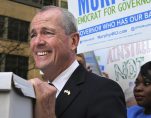 New Jersey Democratic gubernatorial candidate Phil Murphy rests his hand on a box of petitions as he answers a question before delivering the petitions to meet Monday's deadline for candidates to file petitions to run, Monday, April 3, 2017, in Trenton, N.J. (Photo: AP)