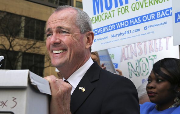 New Jersey Democratic gubernatorial candidate Phil Murphy rests his hand on a box of petitions as he answers a question before delivering the petitions to meet Monday's deadline for candidates to file petitions to run, Monday, April 3, 2017, in Trenton, N.J. (Photo: AP)