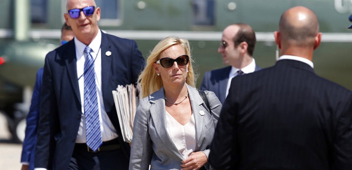 Kirstjen Nielsen, Chief of Staff of U.S. Department of Homeland Security, center, walks to Air Force One as she departs Tuesday, Aug. 22, 2017, at Andrews Air Force Base, Md. President Donald Trump is en route to Arizona and Nevada. (AP Photo/Alex Brandon)