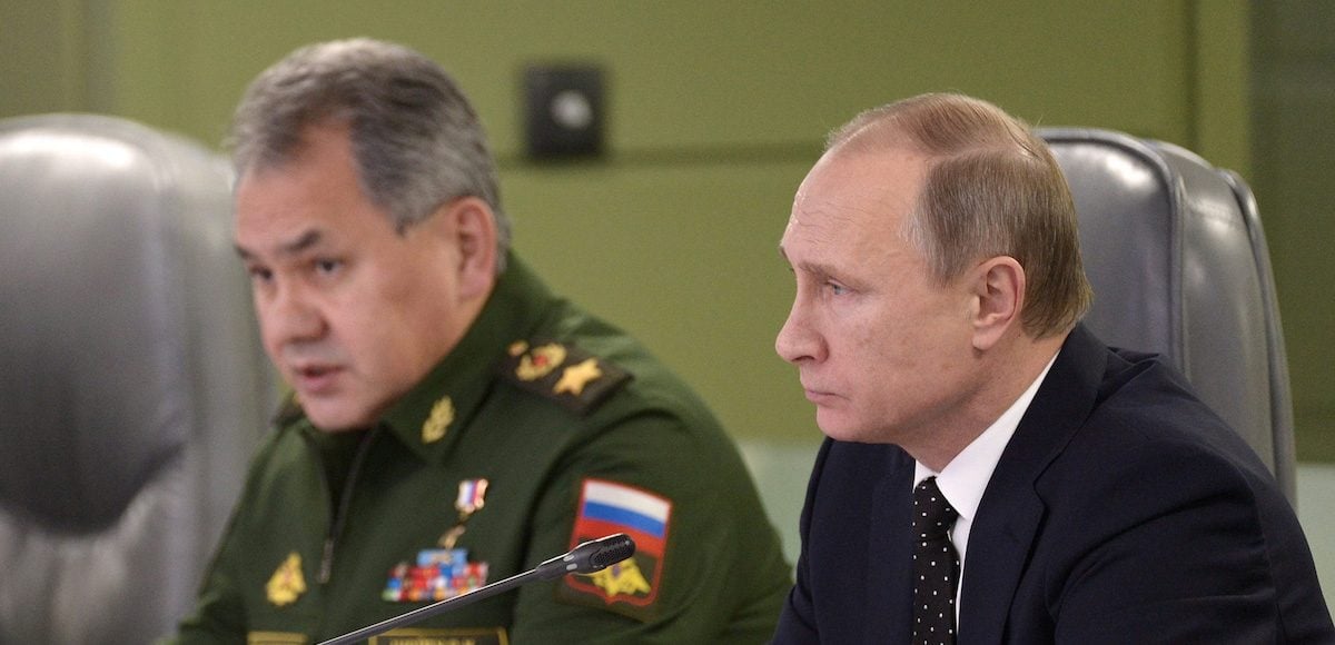 Russian President Vladimir Putin, right, with Defence Minister Sergei Shoigu, left, attend a meeting on Russian air force's activity in Syria at the national defense control center in Moscow, Russia, November 17, 2015. (Photo: Reuters)