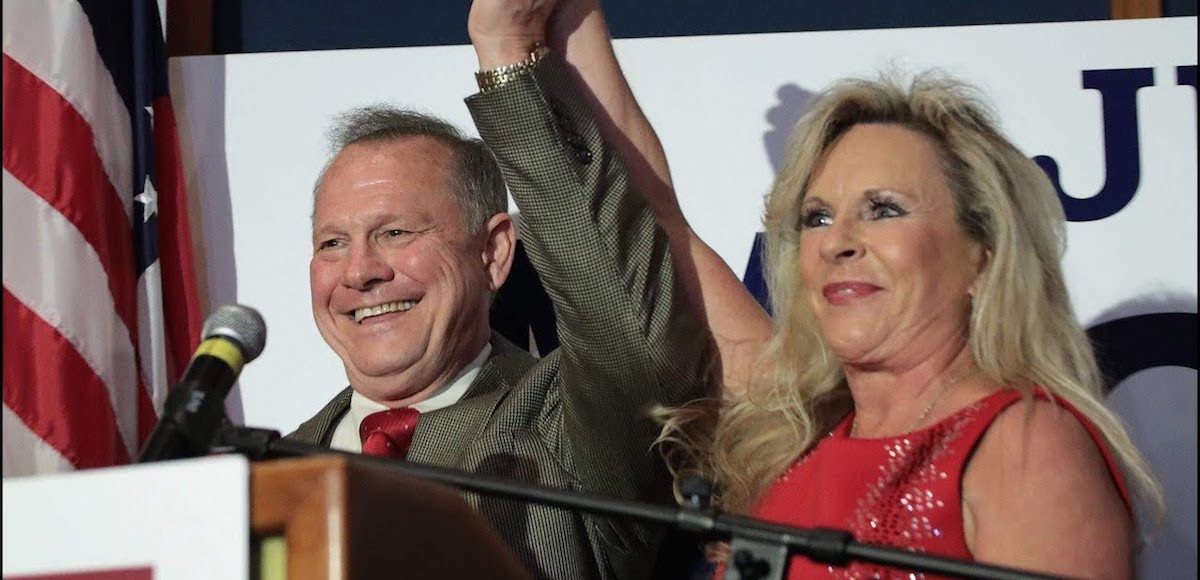 Judge Roy Moore, left, and his wife Kayla Moore, right, celebrate his primary victory over incumbent Senator Luther Strange.