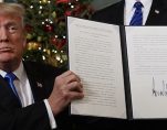 President Donald Trump in the Diplomatic Reception Room of the White House signs an order beginning the process of moving the U.S. Embassy in Tel Aviv, Israel to Jerusalem on December 6, 2017.