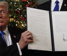 President Donald Trump in the Diplomatic Reception Room of the White House signs an order beginning the process of moving the U.S. Embassy in Tel Aviv, Israel to Jerusalem on December 6, 2017.