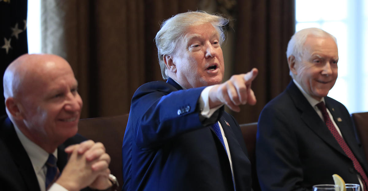 President Donald Trump, flanked by Rep. Kevin Brady, R-Texas, left, and Sen. Orrin Hatch, R-Utah, right, speaks during a bicameral meeting with lawmakers working on the tax cuts in the Cabinet Room of the White House in Washington, Wednesday, Dec. 13, 2017. (Photo: AP)