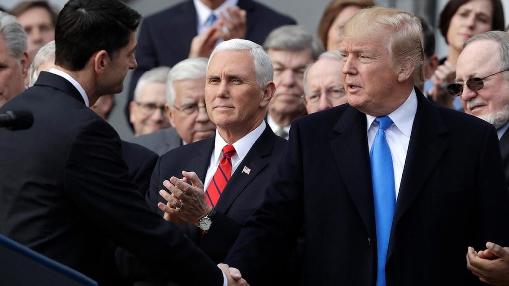 President Donald Trump shakes hands with House Speaker Paul Ryan of Wis., as Vice President Mike Pence and Congressional Republicans look on during a celebratory bill passage event following the final passage of the Tax Cuts and Jobs Act by Congress. (Photo: AP)