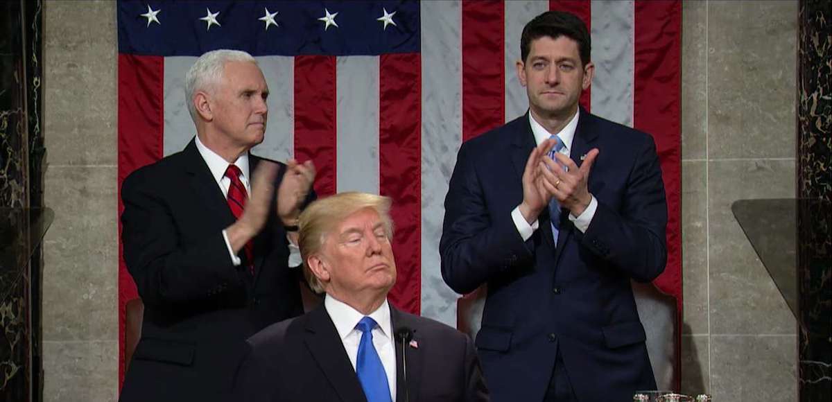 President Donald Trump delivers his first State of the Union address as Vice President Mike Pence, left, and House Speaker Paul Ryan, right, stand for applause.