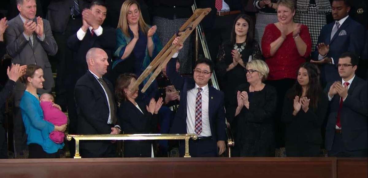North Korean defector Ji Seong-ho raises his crutches as President Donald Trump delivers the State of the Union address at the U.S. Capitol in Washington, D.C. on Jan. 30, 2018.