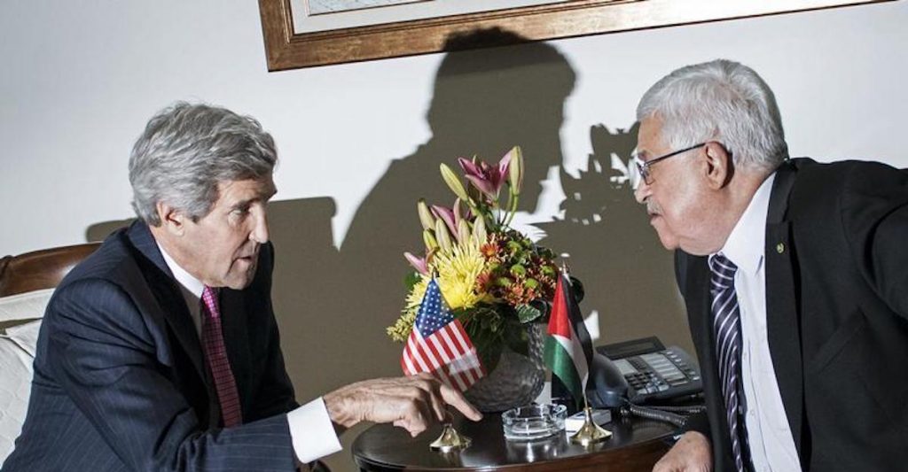 Former U.S. Secretary of State John Kerry, left, and Palestinian President Mahmoud Abbas, right, talk at a meeting at the presidential compound in the West Bank city of Ramallah January 4, 2014. (Photo: Reuters)