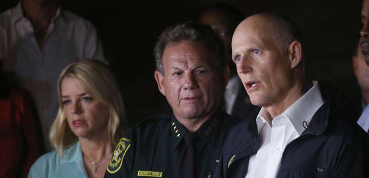 Florida Governor Rick Scott, foreground, speaks along with Sheriff Scott Israel, center, of Broward County, and Pam Bondi, Florida Attorney General, during a news conference near Marjory Stoneman Douglas High School in Parkland on Wednesday, February 14, 2018. (Photo: AP)
