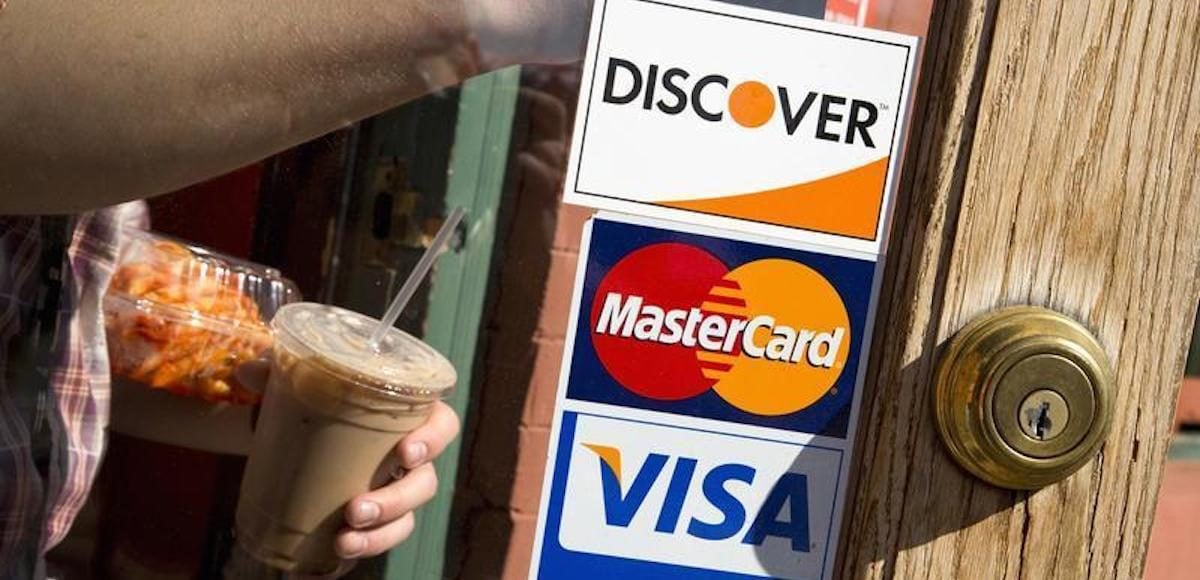 A coffee shop displays signs for Visa, MasterCard and Discover, in Washington, May 1, 2013. (Photo: Reuters)