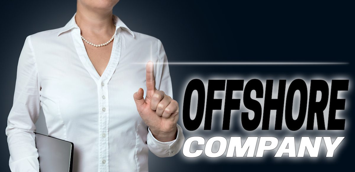 Offshore company touchscreen is operated by businesswoman background. (Photo: AdobeStock/wsf-f)