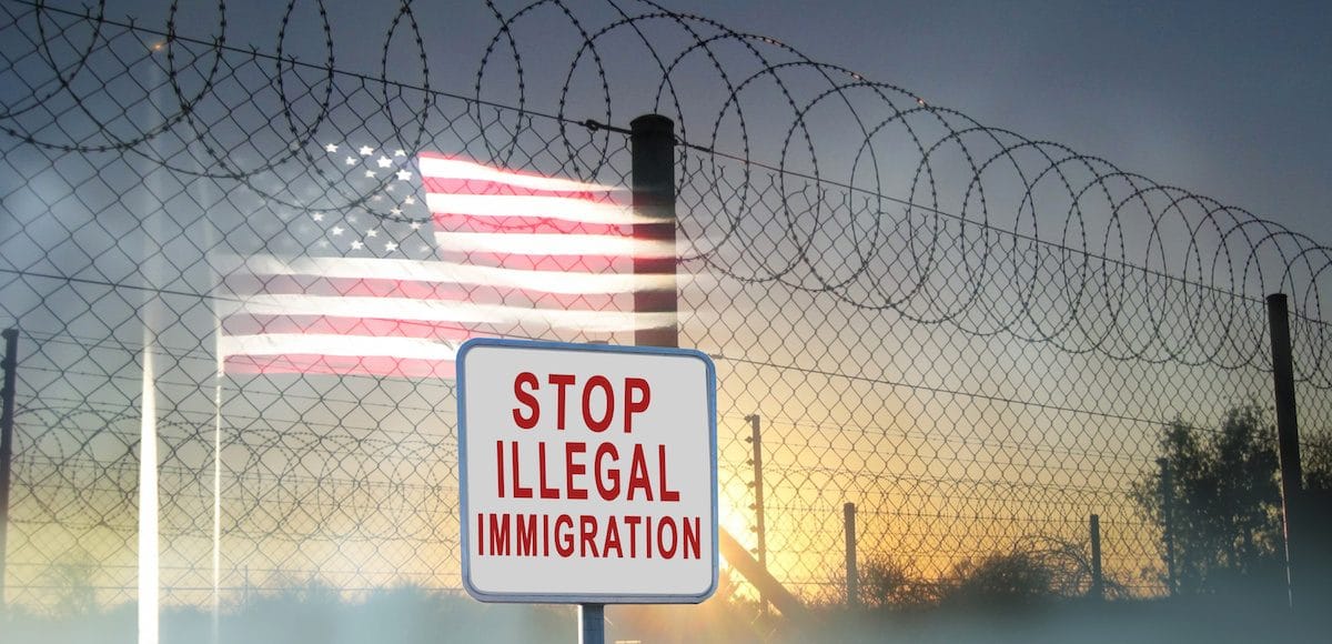 A graphic concept of barbed-wire, chain-linked fencing at the U.S. southern border with a sign reading, "Stop Illegal Immigration." (Photo: AdobeStock/Thea Photography)