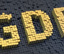 Gross domestic product (GDP) graphic concept with yellow square pixels on a black matrix background. (Photo: AdobeStock)